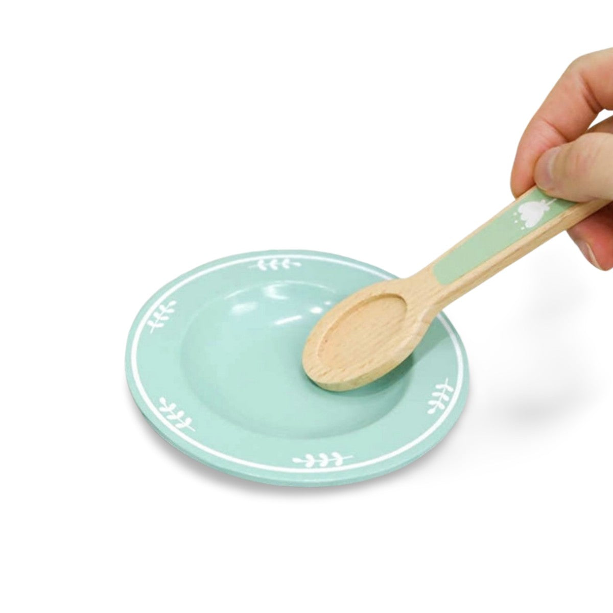 Close-up of wooden plate and spoon from Montessori kitchen set for pretend cooking activities