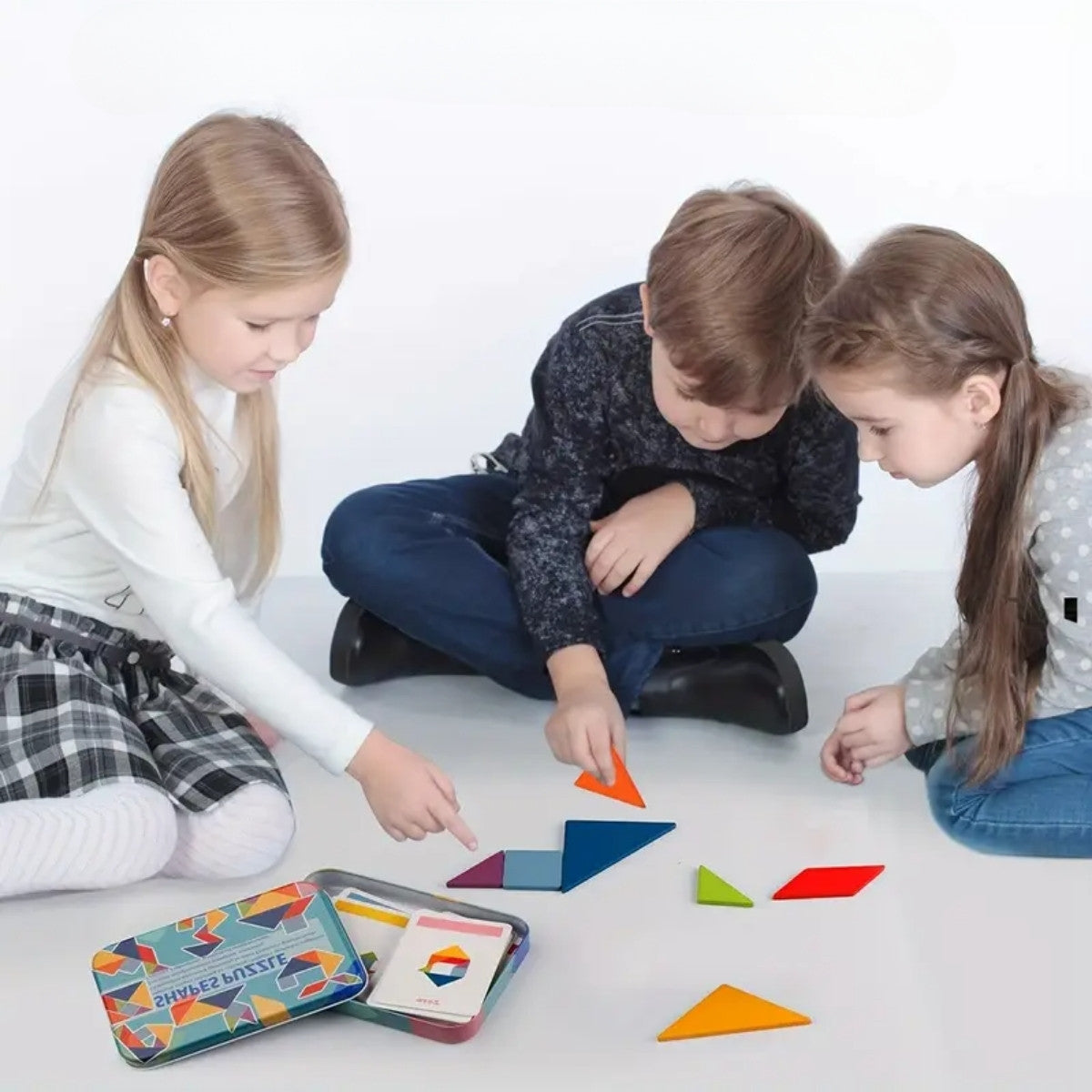 Children playing and assembling shapes with wooden tangram puzzle pieces for creative learning