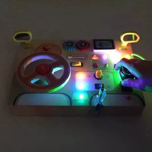 Montessori wooden car dashboard glowing with colorful LED lights in the dark