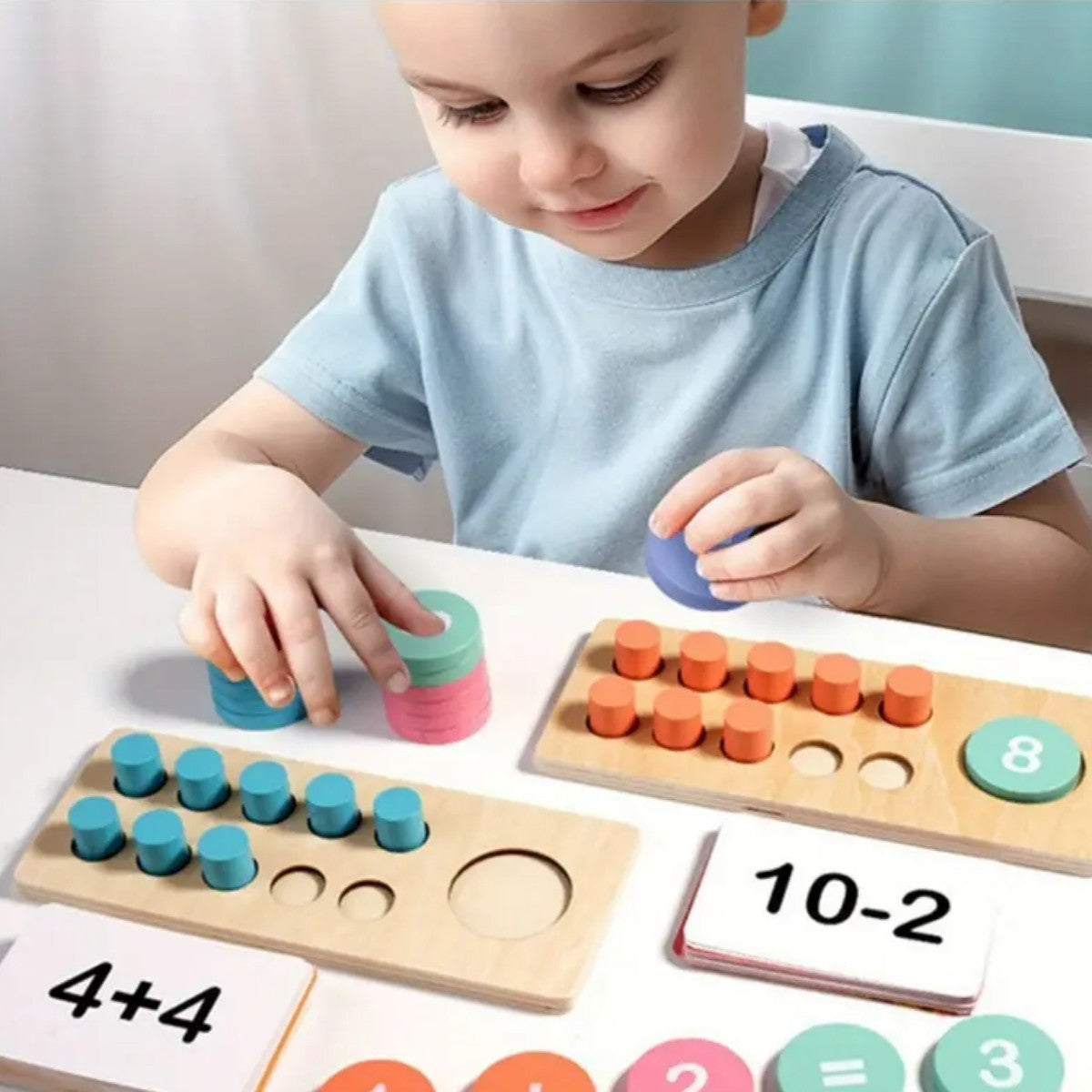 Toddler practicing addition using Montessori wooden ten frame and number chips
