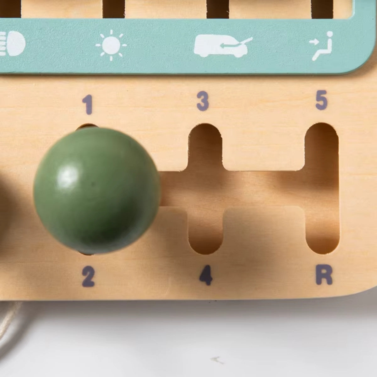 Close-up of wooden gear shifter on Montessori busy car board for fine motor skill development