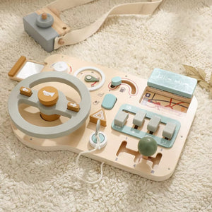 Montessori busy wooden car board placed on a rug for home play environment